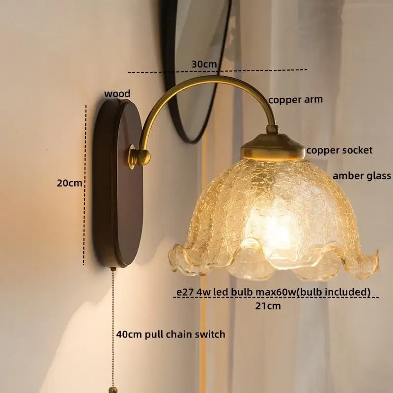 Antique brass led wall lights with textured amber glass shade and wooden backplate for bedroom sconce lighting