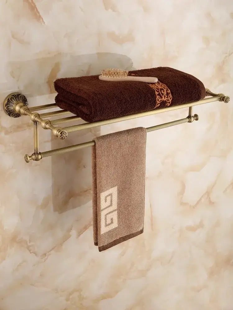 Antique brass floral hardware set bathroom double tier towel rack with ornate scrollwork holding brown and beige towels