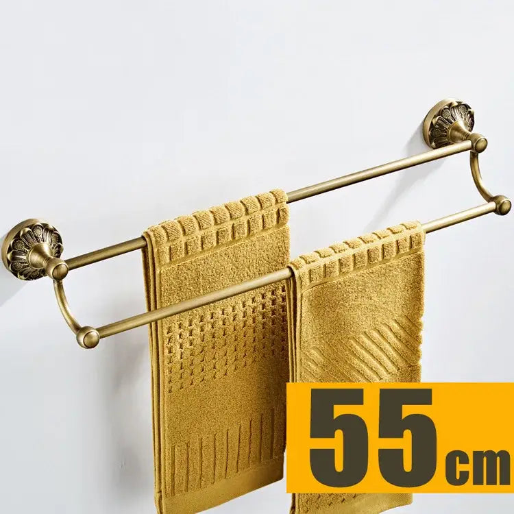 Antique brass floral hardware set bathroom double tier towel rack with ornate shell-shaped ends holding golden towels