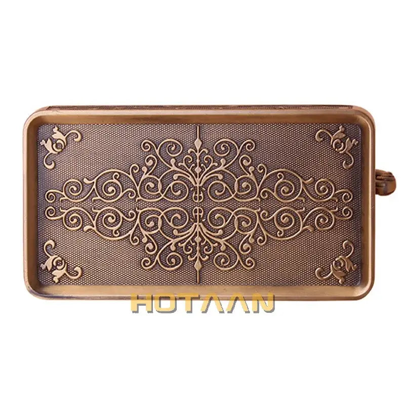 Antique brass floral toilet paper holder with phone rack featuring an antique bronze rectangular tray with scrollwork design and handle on the right side