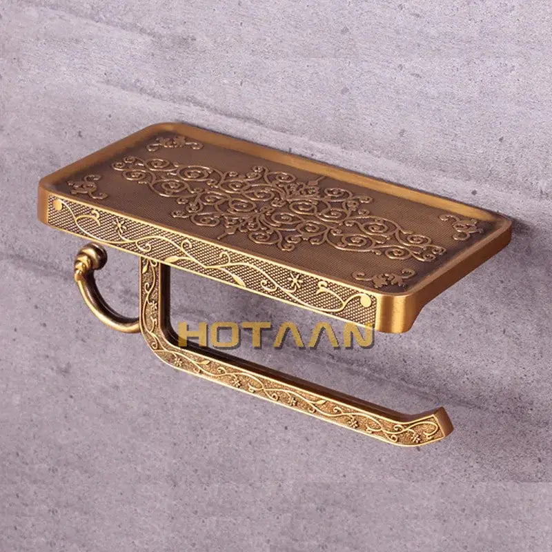 Antique brass floral toilet paper holder with ornate scrollwork and decorative shelf for bathroom phone rack use
