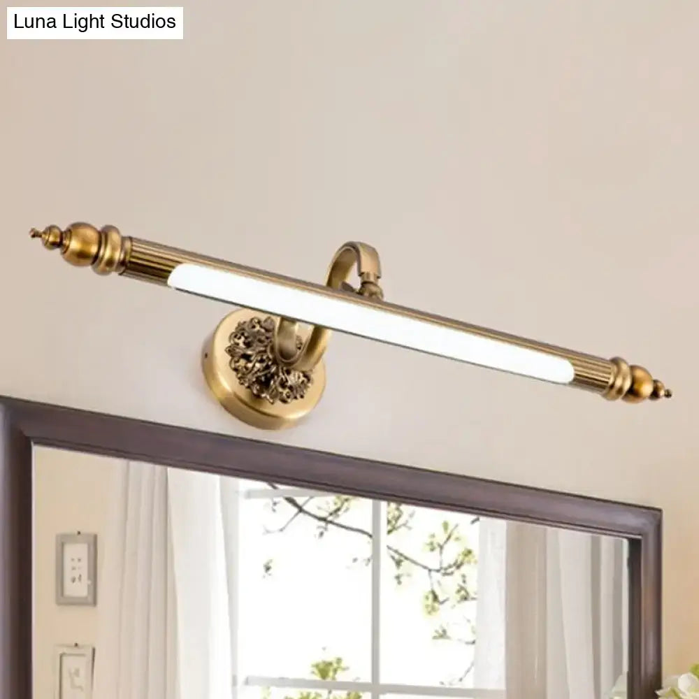 Antique brass finish wall lamp with ornate floral detailing and sleek elongated led bar emitting warm white light