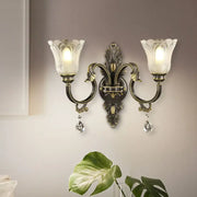 Antique brass floral wall sconce with metal base two-light design frosted glass tulip shades 15 inches tall for bedroom
