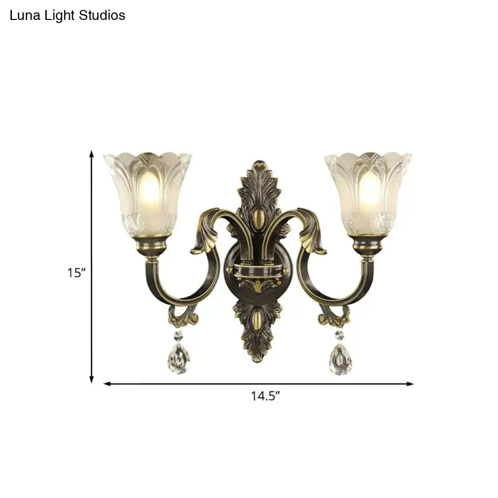 Antique brass floral wall sconce with metal base two-light frosted glass shades and dangling crystal teardrops inches tall
