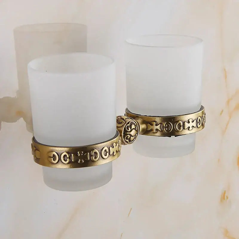 Antique brass glass cup holder set with brass antique finish and ornate cross-patterned frosted glass cups for bathroom decorbites