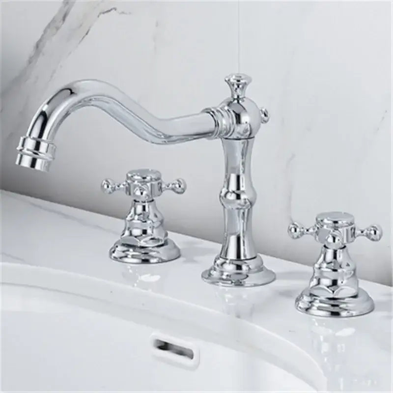 Antique brass gold finish bathroom sink faucet with chrome finish curved spout and two vintage cross-handle knobs