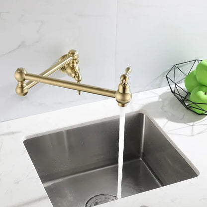 Antique brass gooseneck pot filler tap with ornate handles above stainless steel sink for kitchen use