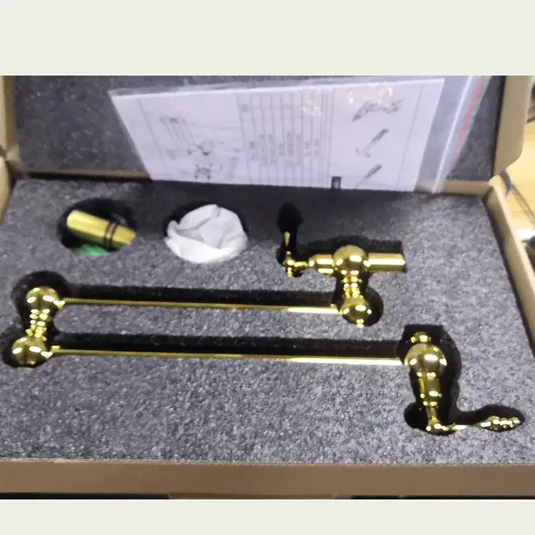 Antique brass gooseneck pot filler tap with gold-finished brass towel rack and ornate vintage-style handles