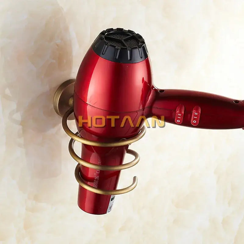 Red handheld hair dryer with black nozzle mounted in antique brass decorbites brass hair triple loop wall rack bathroom shelf