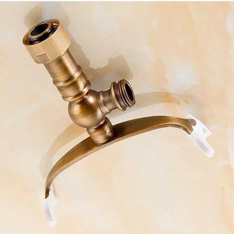 Antique brass hand shower holder hook with curved spout and two threaded connections for bathroom pedestal bracket