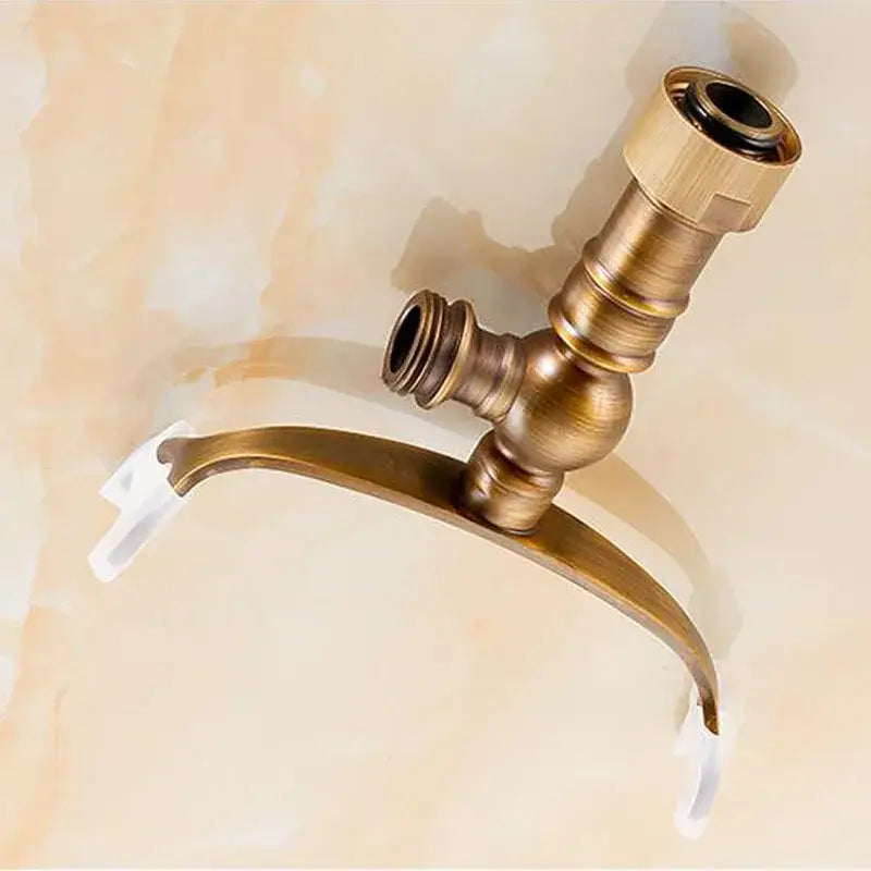 Antique brass hand shower holder hook with curved spout and two threaded connections for bathroom pedestal bracket