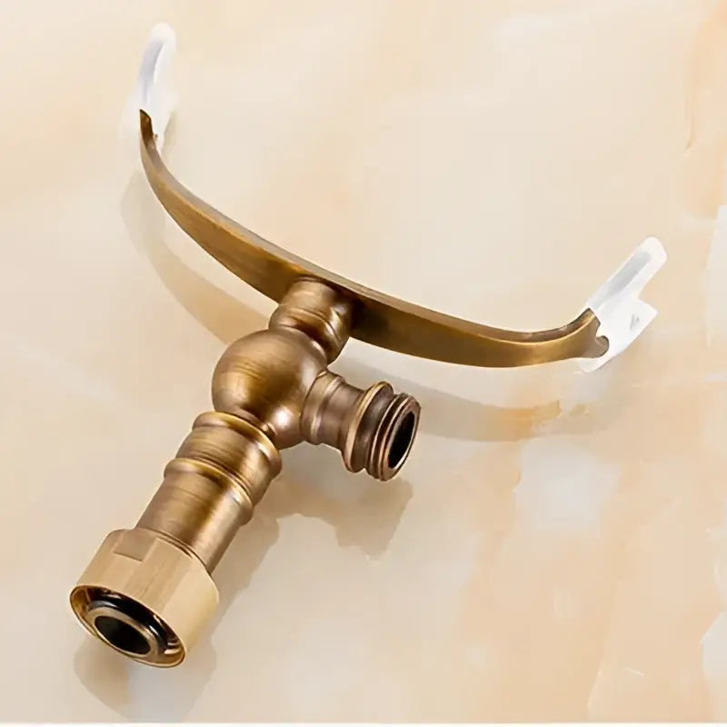 Antique brass hand shower holder hook with arched design and two threaded outlets for bathroom pedestal bracket