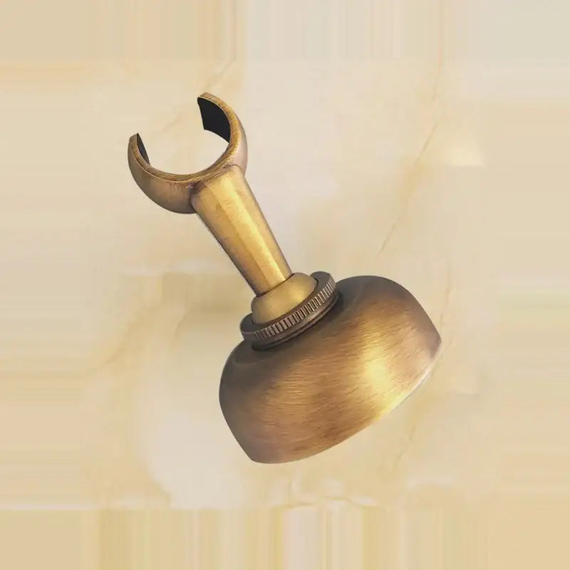 Antique brass curtain rod holder with curved hook and textured base for hand shower set bathroom installation