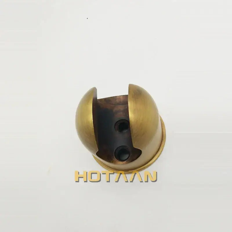 Brass-colored spherical wall-mounted hook with split design and two circular holes for antique brass hand shower set