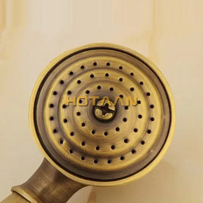 Antique brass hand shower with concentric circular perforations in hand shower set featuring wood grip for bathroom use