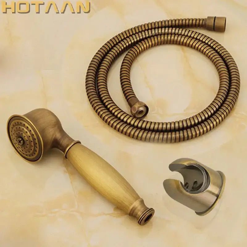 Antique brass hand shower set with wooden-textured grip and matching coiled hose with wall-mounted bracket