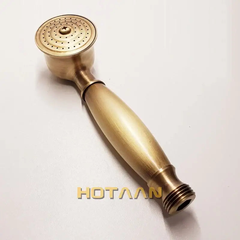 Antique brass handheld shower head with textured circular spray face and smooth tapered handle for bathroom use