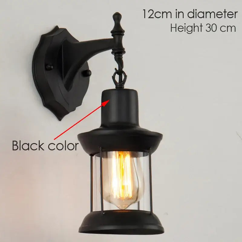 Black wrought iron wall lamp with decorbites industrial glass lantern and exposed filament bulb for bedroom sconce use