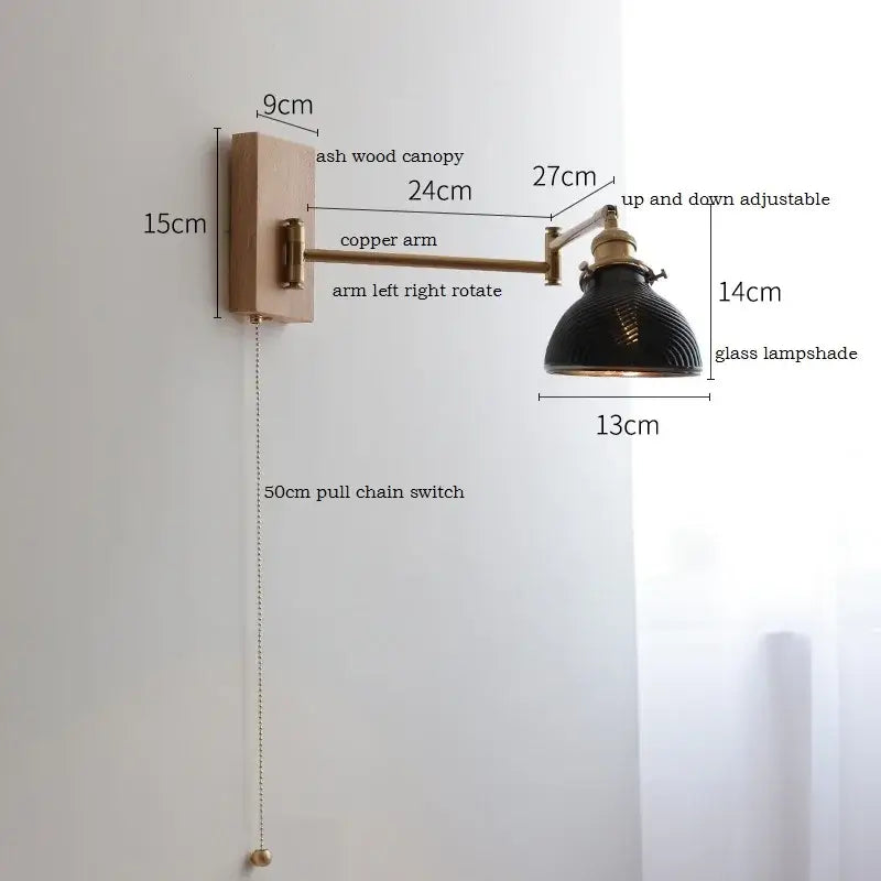 Antique brass industrial wall light with clear glass featuring matte black glass lampshade and copper arm decorbites clear glass