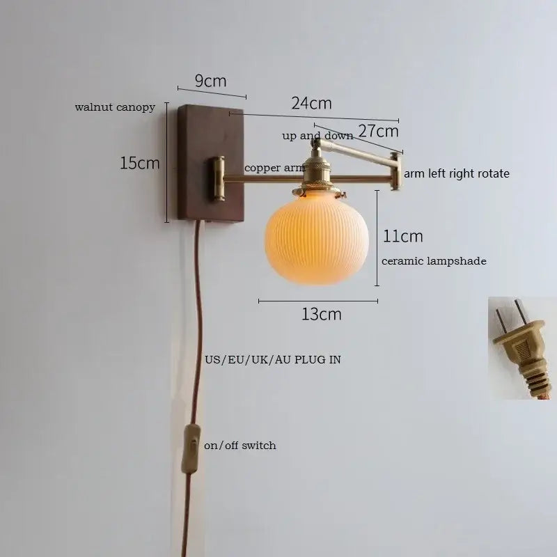 Antique brass industrial wall light with clear glass featuring a warm-toned ceramic lampshade on a walnut canopy