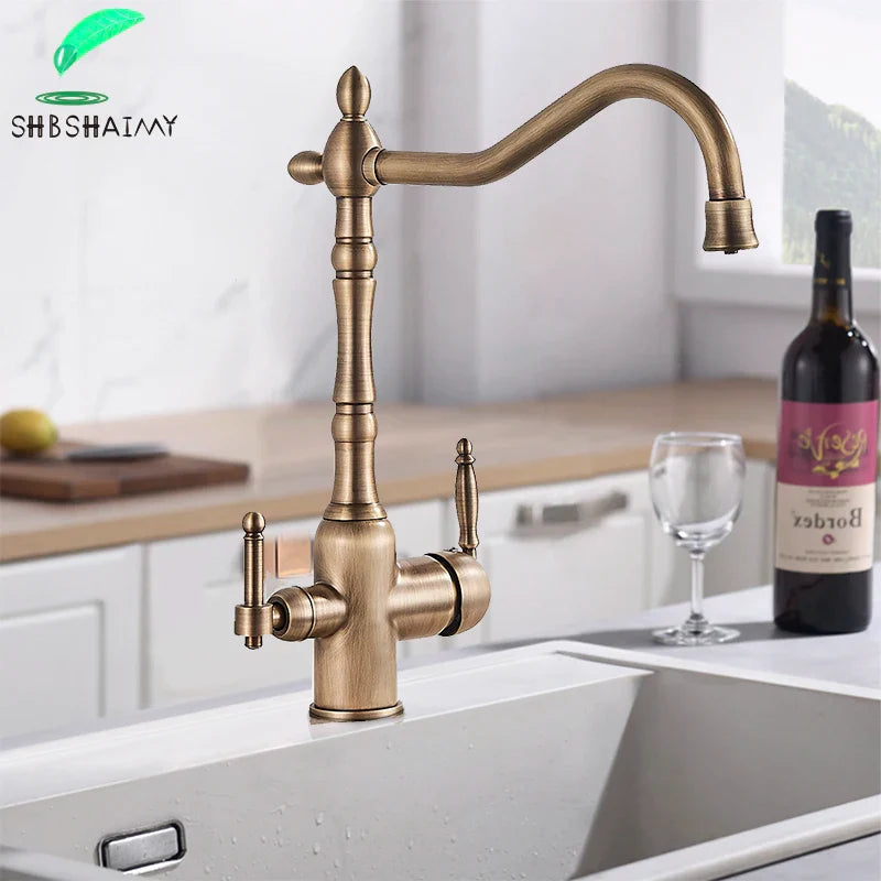 Antique brass kitchen faucet with dual handles featuring an ornate vintage-inspired design in brass finish