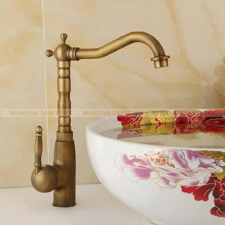 Antique brass ornate decorbites basin sink faucet with vintage-style curved spout and detailed design for bathroom use