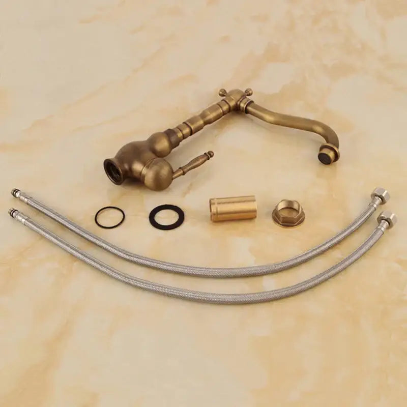 Antique brass ornate decorbites basin sink faucet with vintage design and matching flexible metal hoses for bathroom use