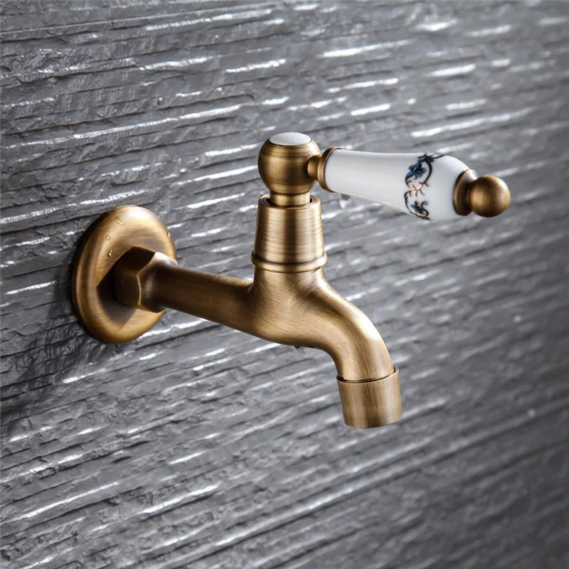 Antique brass outdoor faucet with single hole white ceramic handle and blue floral patterns housing material metal