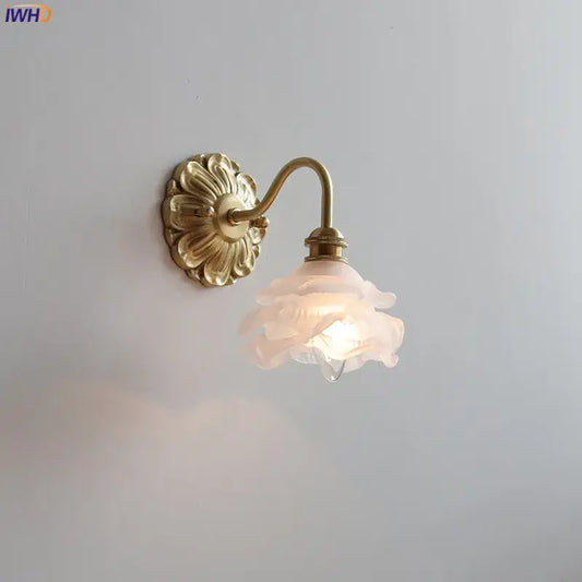 Antique brass wall lamp with a pink frosted glass rose shade by decorbites for elegant bedroom decor