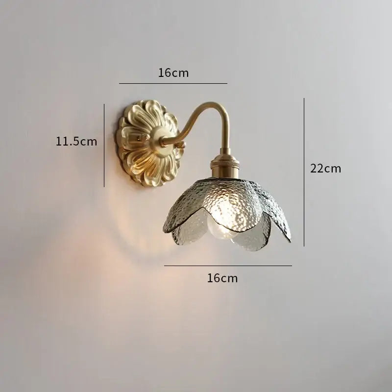 Gold-toned antique brass ceramic led wall light with ribbed open flower glass shade for bedroom decorbites ceramic led wall