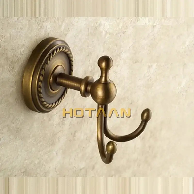 Antique brass double hook towel rack with ornate rope detailing on circular wall plate brass wall hooks decorbites wall hooks