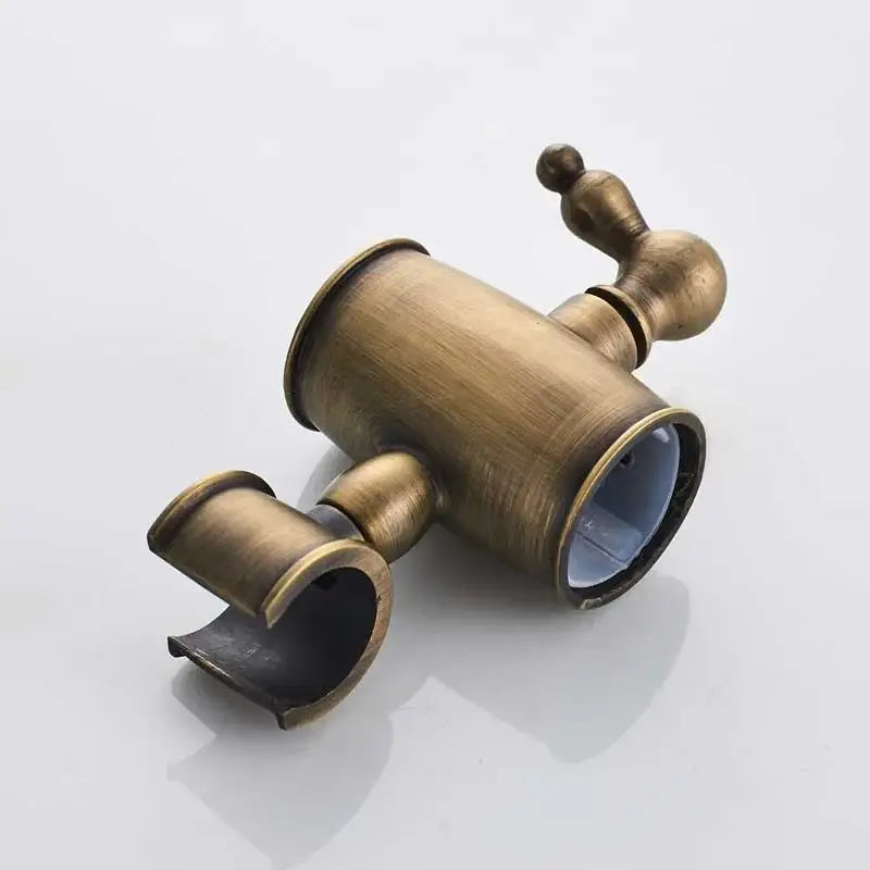Antique brass round shower faucet set with dual spout and ornate design featuring a handheld sprayer faucet set