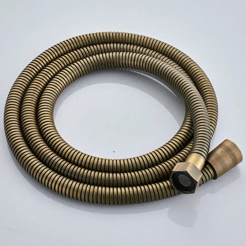 Brass-colored corrugated shower hose with hexagonal connector and textured nozzle in antique brass shower faucet set