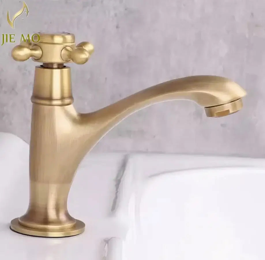 Antique brass-finished single handle basin faucet with curved spout and cross-shaped handle for bathroom use
