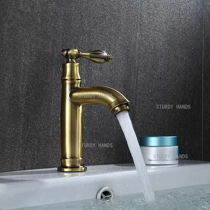 Antique brass single-handle bathroom faucet with classic design and flowing spout for bathroom sink fixture