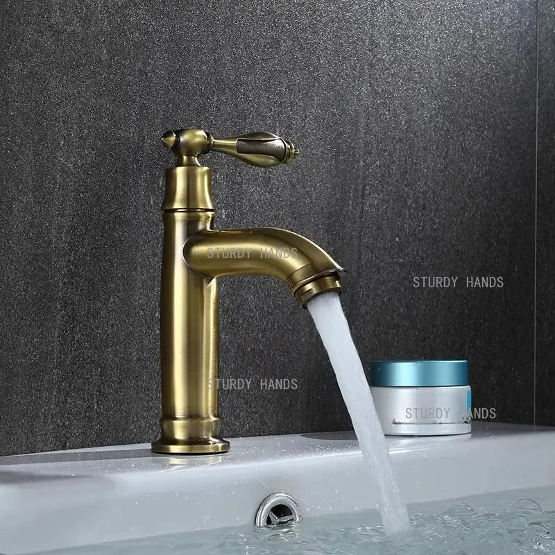 Antique brass single-handle bathroom faucet with classic design and flowing spout for bathroom sink fixture