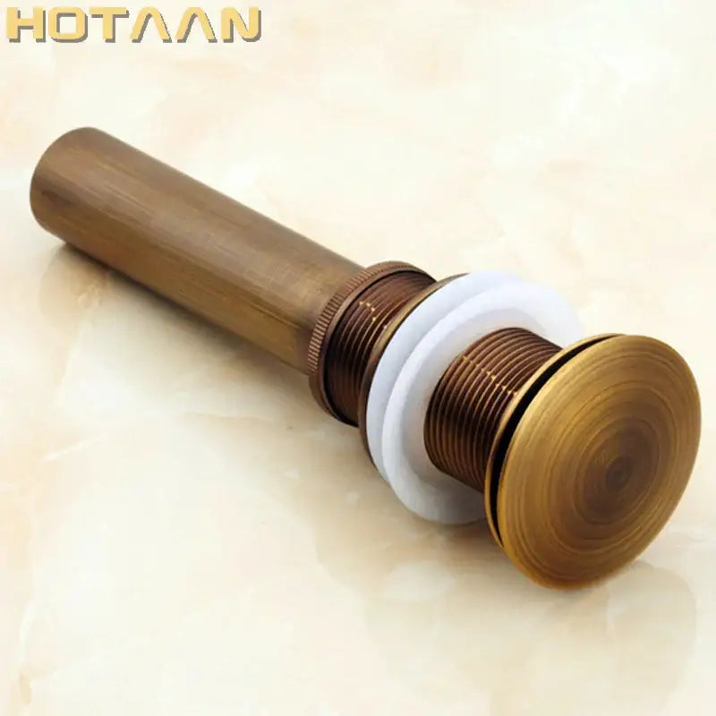 Antique brass sink drain with white rubber seal and threaded metal fittings for bathroom waste by decorbites brass pop