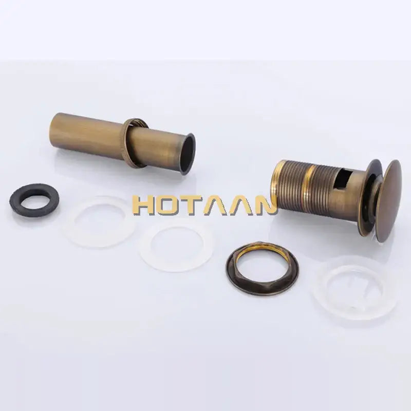 Antique brass sink drain with threaded body and flanged cover featuring a white rubber seal for bathroom use by decorbites brass