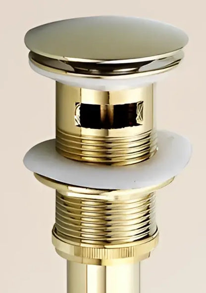 Antique brass sink drain with shiny brass finish, circular chrome top, threaded body, and white rubber seal by decorbites brass