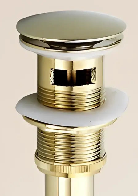 Antique brass sink drain with shiny brass finish, circular chrome top, threaded body, and white rubber seal by decorbites brass