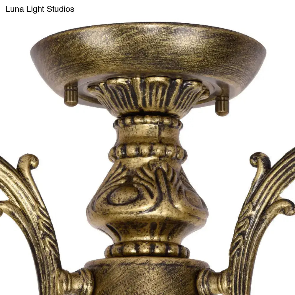 Antique brass-finished DecorBites™ Tiffany style chandelier with ornate scrollwork and blue stained glass bell shades
