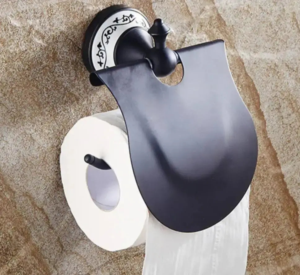Black matte-finished paper holder with ornate circular backplate and curved cover for decorbites brass wall mounted use