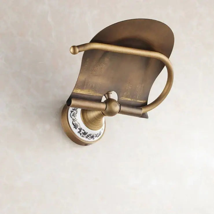 Antique brass wall mounted paper holder with decorative ceramic base featuring black floral patterns for bathroom decorbites brass wall mounted use