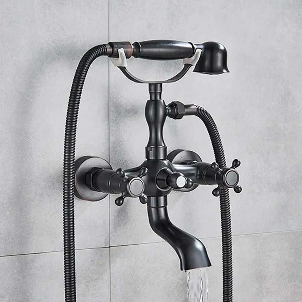 Black matte-finished brass bathtub faucet with three cross handles and handheld showerhead decorbites dual handle design