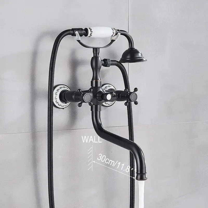 Black matte vintage-style wall-mounted decorbites dual handle bathtub faucet with white ceramic handles and floral patterns