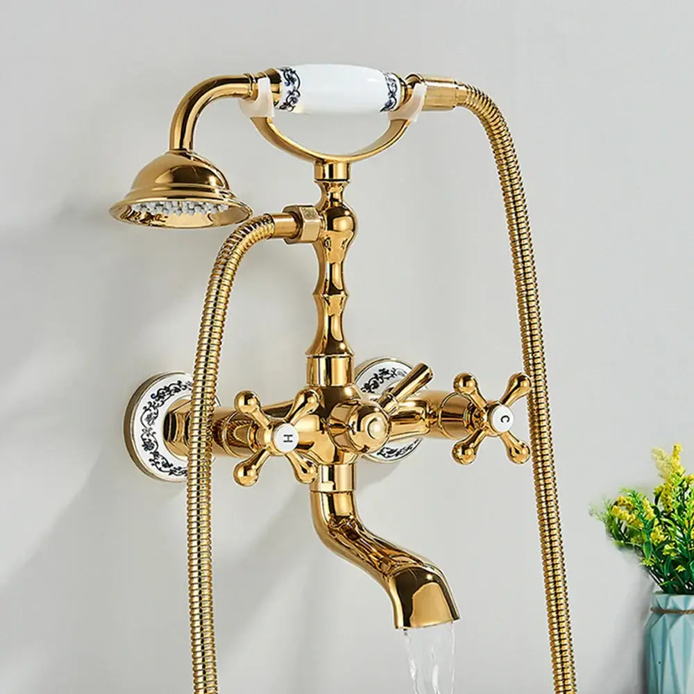 Gold-finished antique brass and white dual handle bathtub faucet with ceramic handle and blue-and-white porcelain decorbites accents