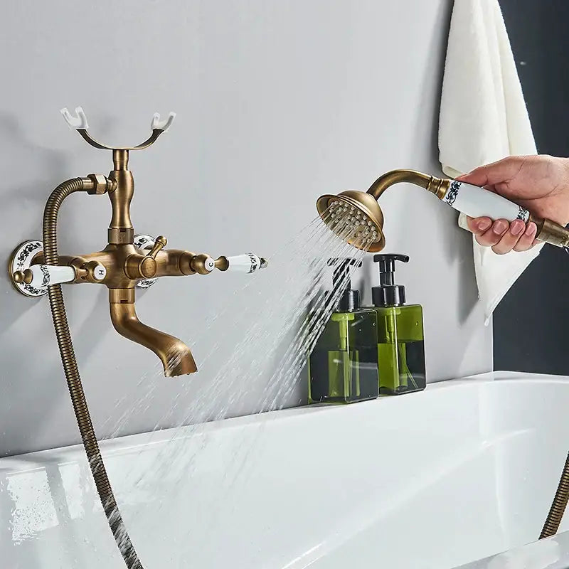 Antique brass bathtub faucet with white ceramic dual handles and ornate detailing for bathroom shower decorbites dual handle