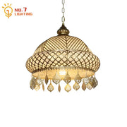 Antique brass pendant lights with intricate woven mesh and dangling teardrop charms in decorbites gold lustre iron style
