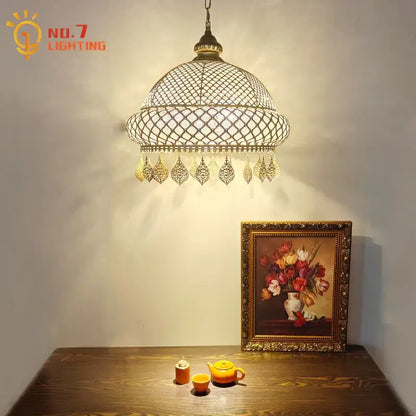 Antique brass gold lustre iron pendant light with ornate lattice design and dangling charms for dining room decorbites pendant lights