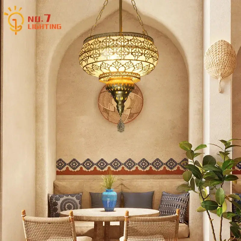 Antique brass gold lustre iron pendant light with intricate floral cutout patterns and warm glowing illumination for dining room decorbites pendant lights